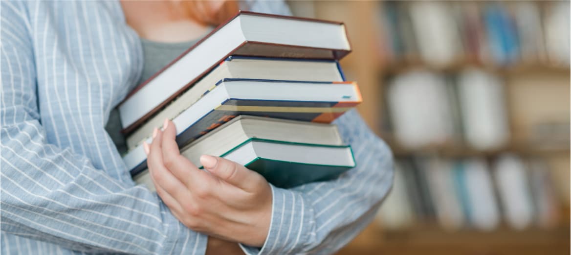Image of student holding textbooks